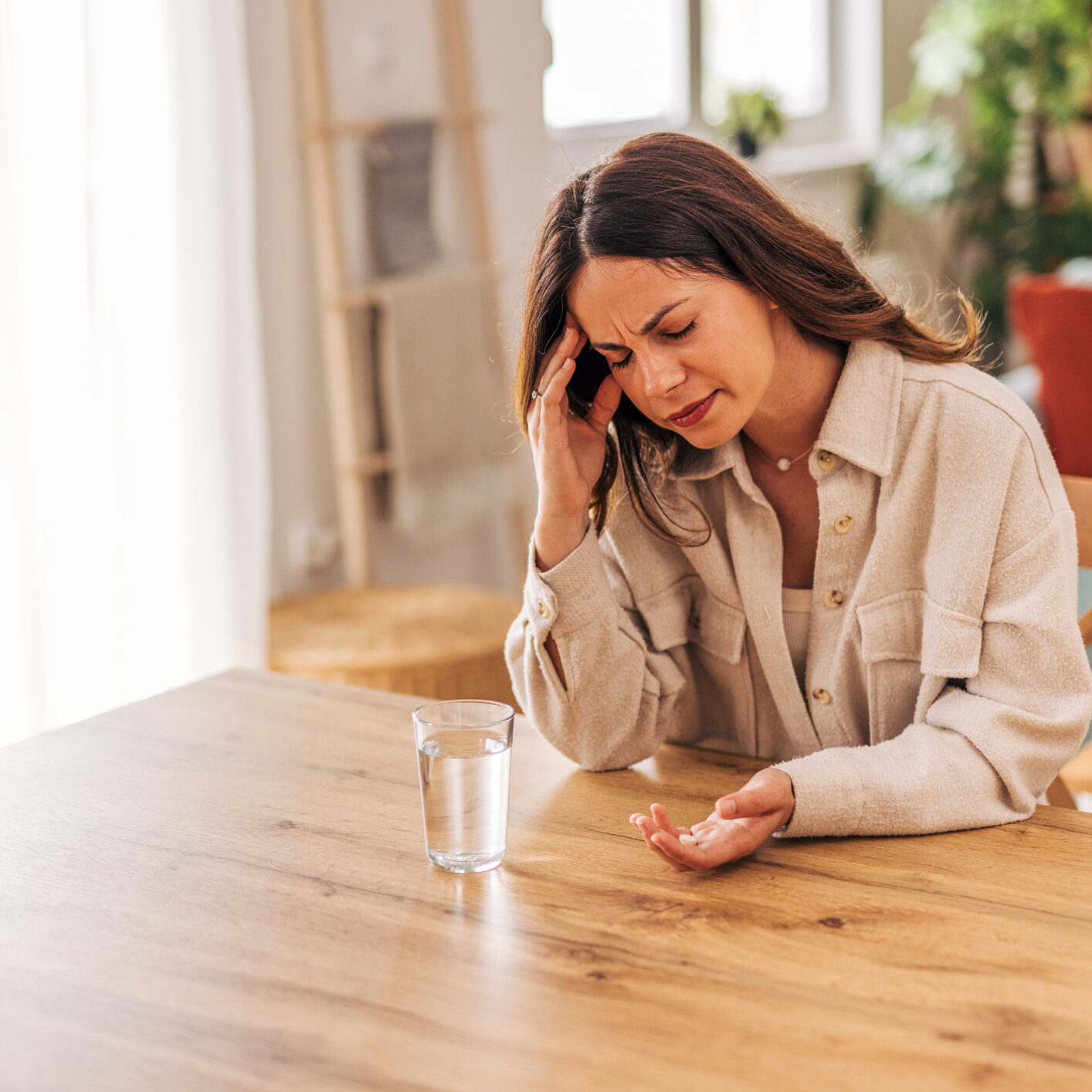 Person stressed at table with medication